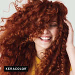 Woman with curly red hair smiling, with Keracolor logo at the bottom.